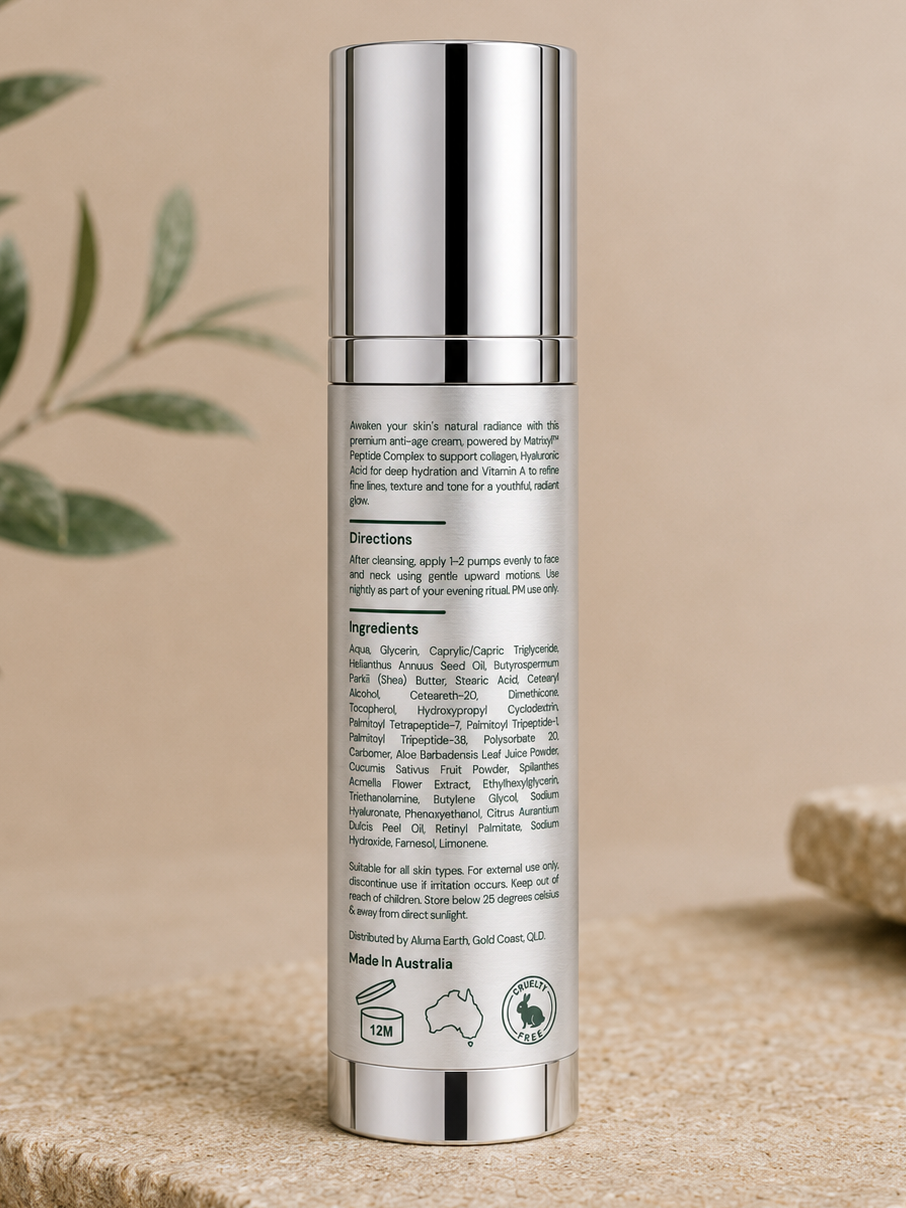 Skincare bottle with silver cap and detailed label on a beige surface with green leaves in the background